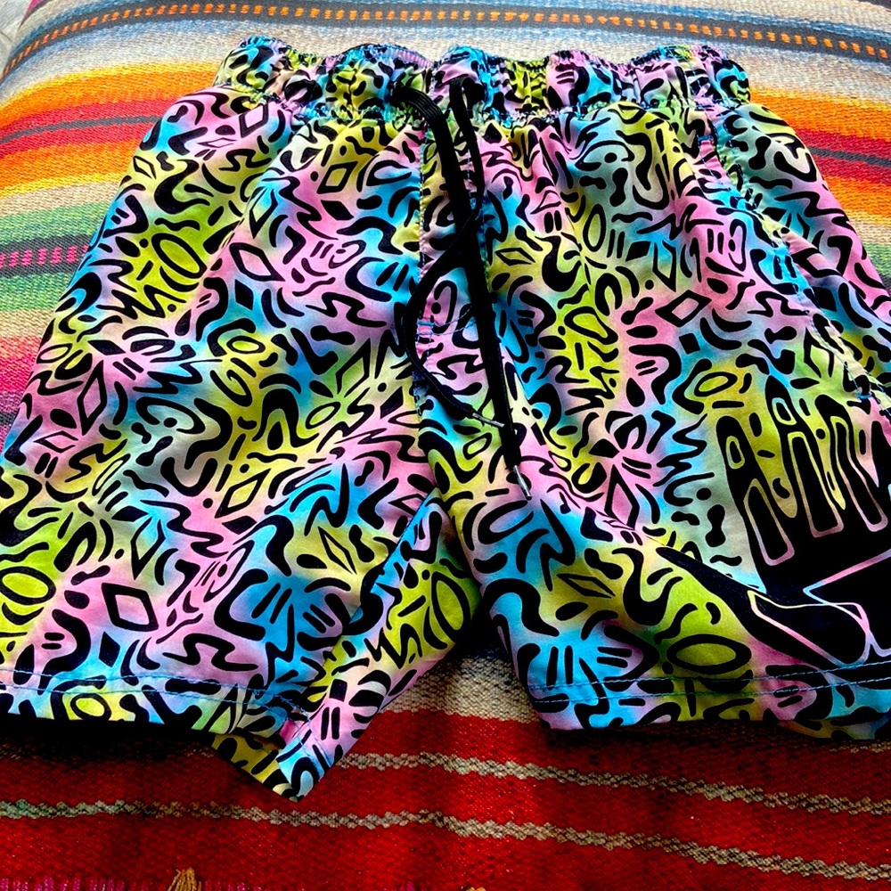 I’m selling a colorful bathing suit. The colors are pink, blue,yellow, and green